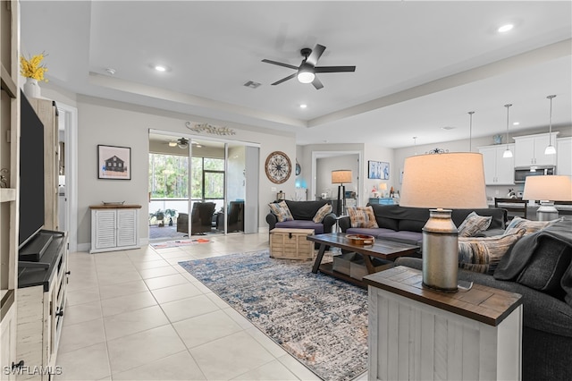 living room featuring ceiling fan and light tile patterned floors