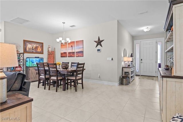 tiled dining space with a notable chandelier