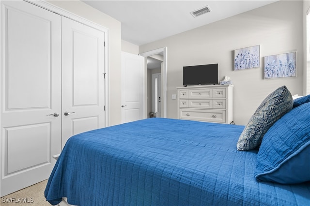 carpeted bedroom with a closet