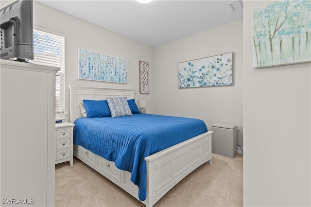 bedroom with light colored carpet