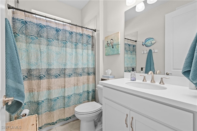 bathroom with vanity, walk in shower, toilet, and tile patterned flooring