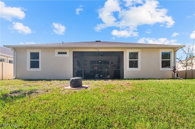 back of property with a lawn