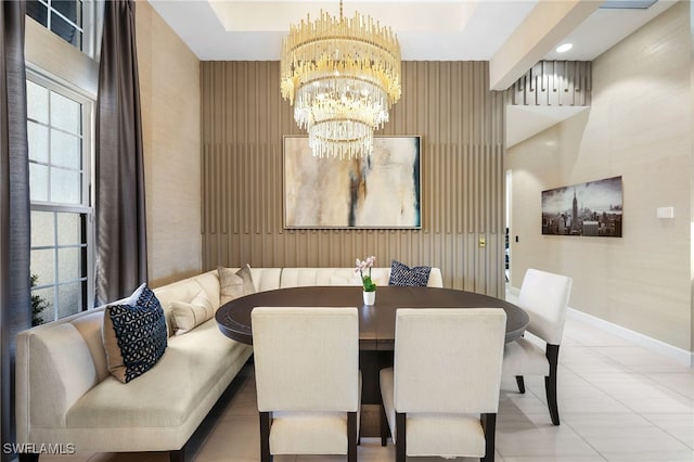 dining area featuring light tile patterned floors and an inviting chandelier