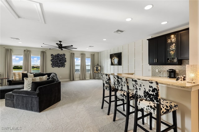 interior space featuring ceiling fan and light carpet