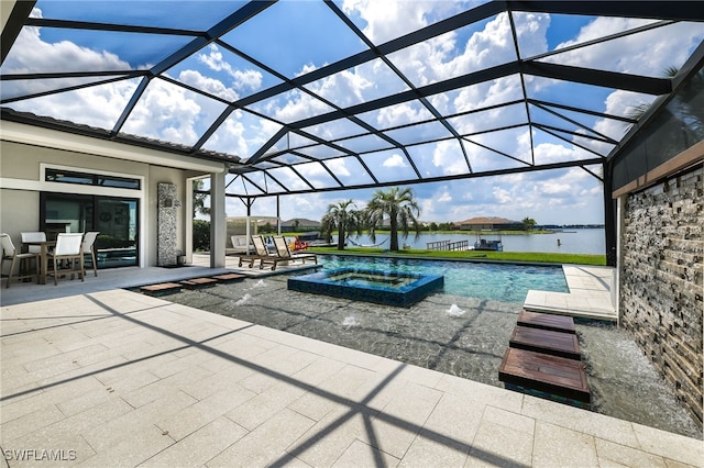 view of swimming pool with glass enclosure, an in ground hot tub, a patio area, and a water view