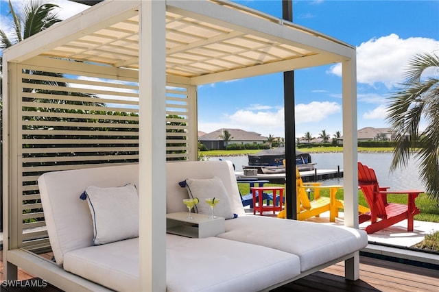 wooden deck with a pergola and a water view