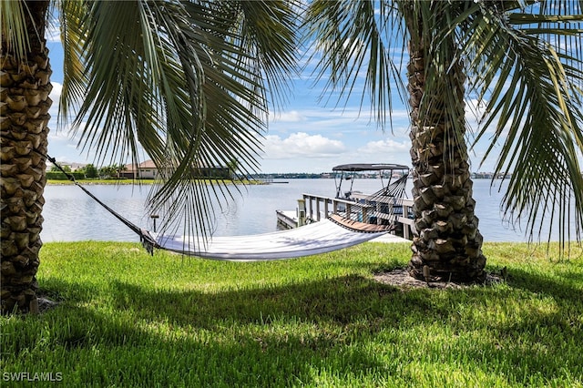 view of dock featuring a water view and a lawn