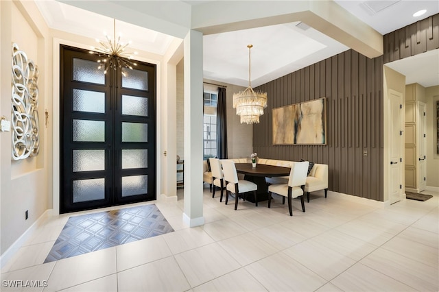 entrance foyer with french doors, crown molding, a notable chandelier, and beam ceiling