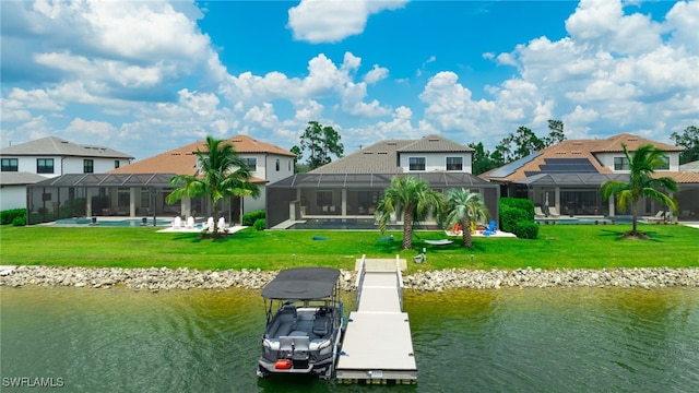 view of dock featuring a water view, glass enclosure, and a lawn