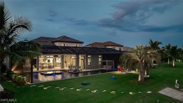 rear view of house featuring a patio, glass enclosure, an outdoor hangout area, and a lawn