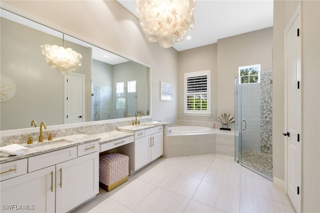 bathroom with a chandelier, shower with separate bathtub, vanity, and tile patterned floors