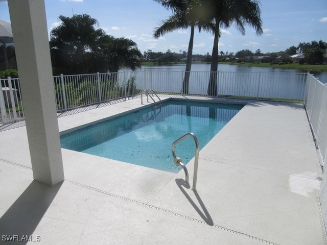 view of pool with a patio area and a water view