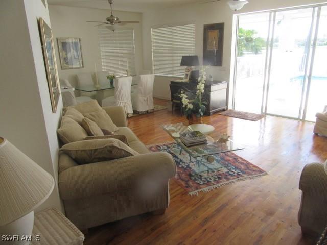 592 Crossfield Cir, Naples, FL 34104 - living room with ceiling fan and wood finished floors