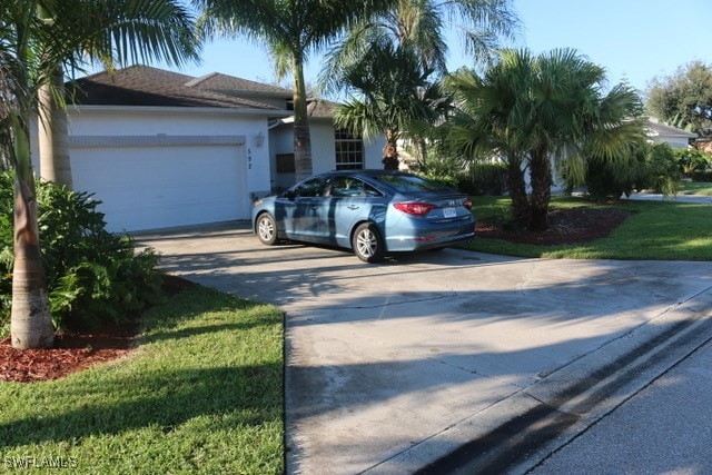 ranch-style home with a garage and a front yard