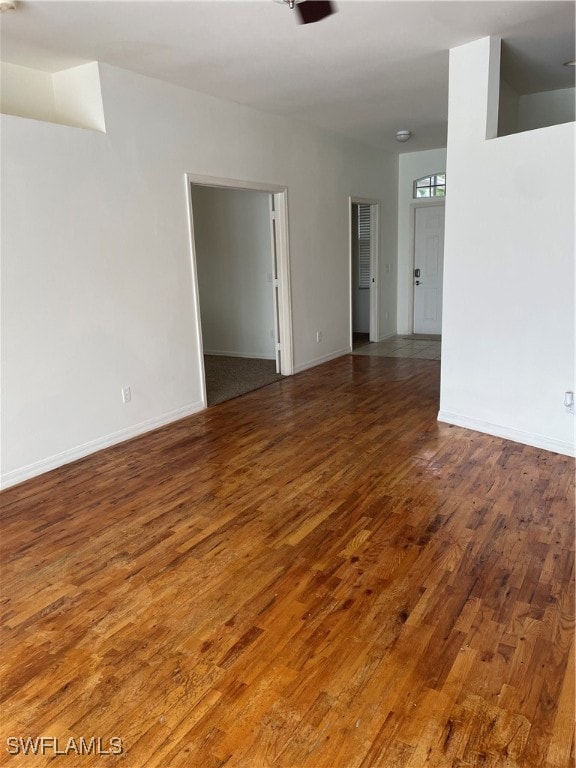 unfurnished room with dark hardwood / wood-style floors