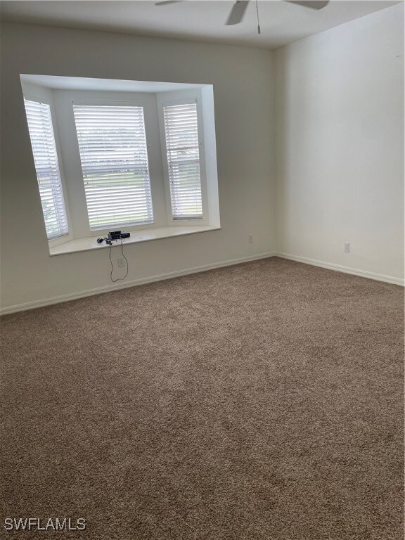 unfurnished room featuring carpet flooring and ceiling fan