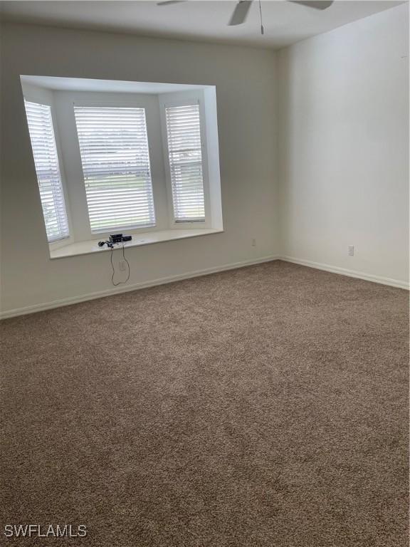 592 Crossfield Cir, Naples, FL 34104 - empty room with carpet, ceiling fan, and baseboards