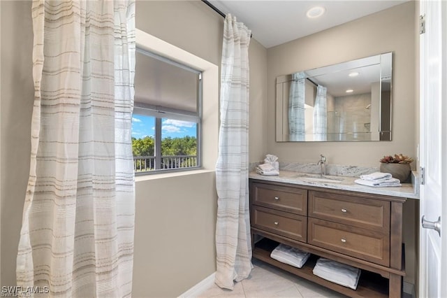 bathroom featuring walk in shower, vanity, and tile patterned flooring