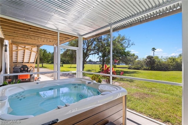 view of pool with a hot tub and a lawn