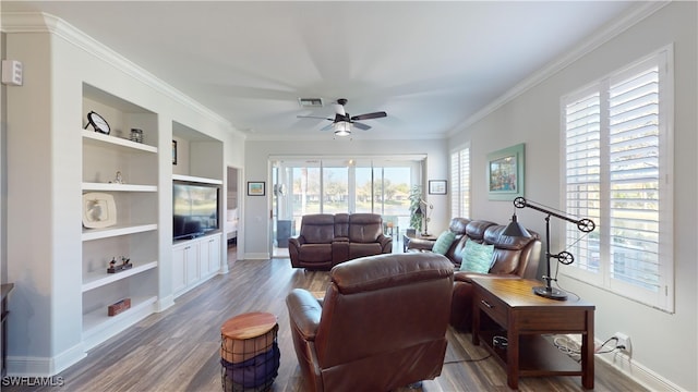 living room with built in shelves, ornamental molding, dark hardwood / wood-style floors, and ceiling fan