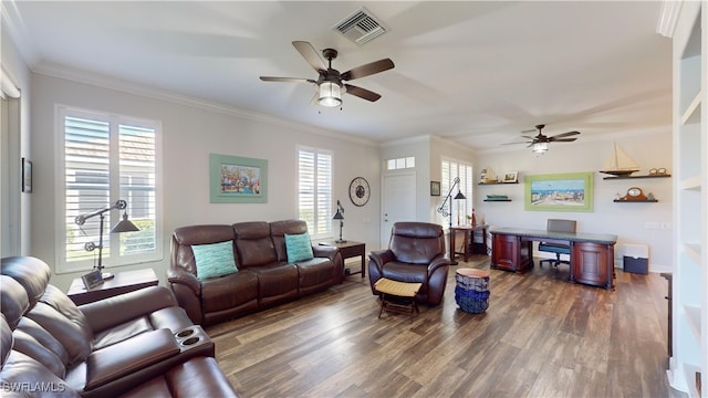 living room featuring dark wood-type flooring, a wealth of natural light, and crown molding