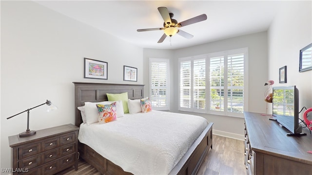 bedroom with hardwood / wood-style floors and ceiling fan