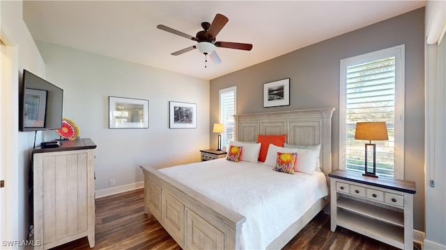 bedroom with dark hardwood / wood-style flooring and ceiling fan