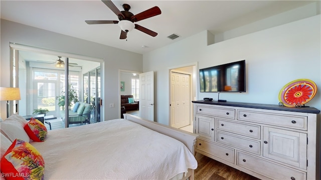 bedroom featuring access to outside, dark hardwood / wood-style flooring, multiple windows, and ceiling fan