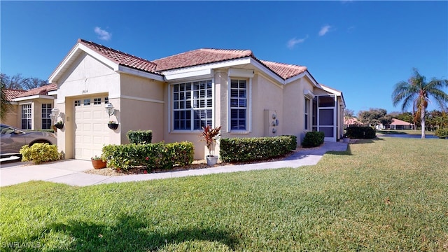 mediterranean / spanish house with a front lawn and a garage