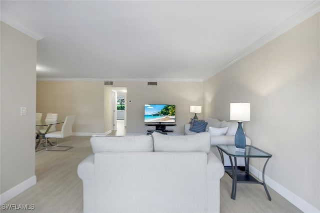 living room featuring crown molding and light hardwood / wood-style flooring