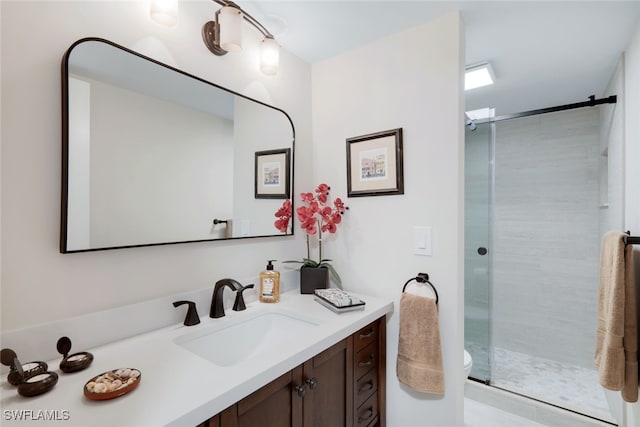 bathroom with an enclosed shower, vanity, and toilet