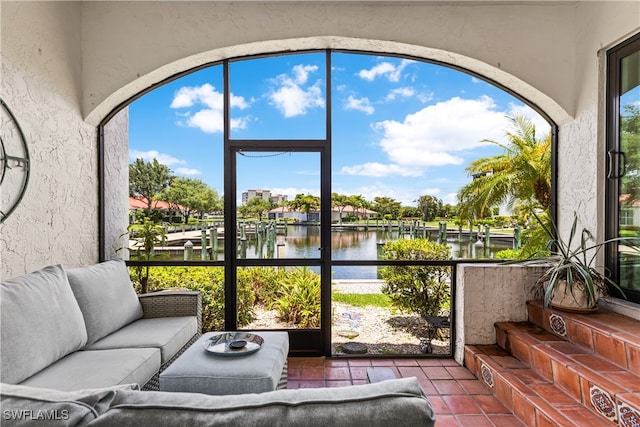 sunroom / solarium with a water view