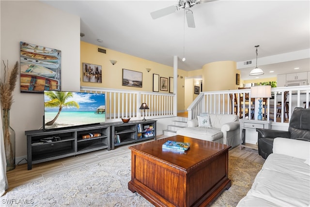 living room with ceiling fan and light hardwood / wood-style flooring