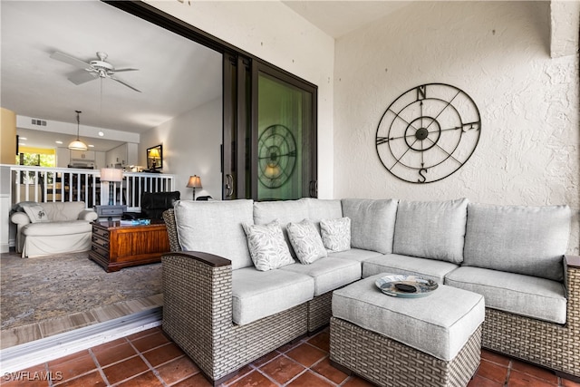 living room with ceiling fan and dark hardwood / wood-style floors