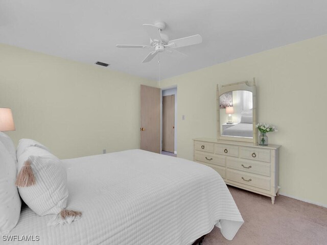 bedroom with light carpet and ceiling fan