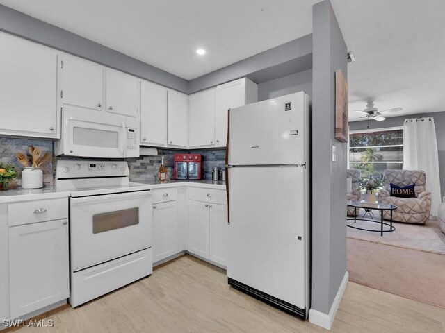 kitchen featuring decorative backsplash, white cabinets, ceiling fan, light wood-type flooring, and white appliances