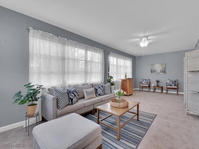 living room with ceiling fan and light colored carpet