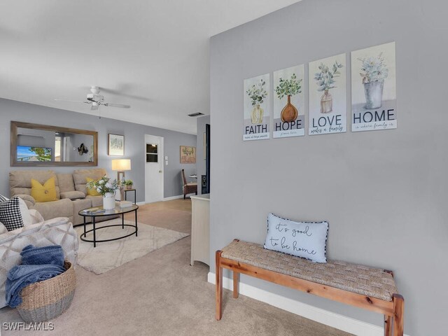 living room with light carpet and ceiling fan