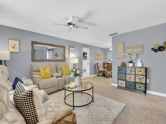 living room featuring light carpet and ceiling fan