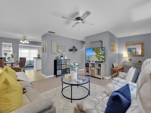 carpeted living room featuring ceiling fan