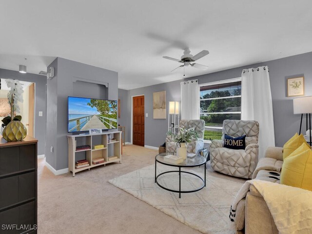 living room featuring light colored carpet and ceiling fan