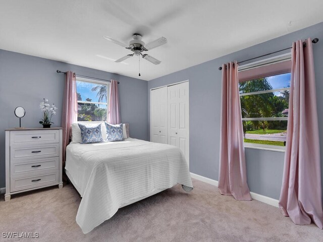 carpeted bedroom featuring a closet and ceiling fan