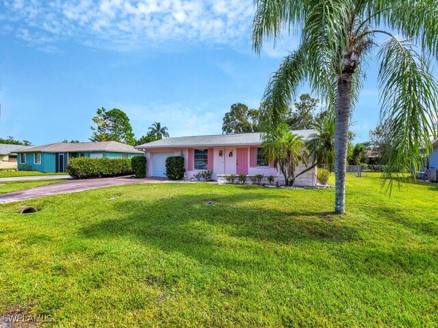 ranch-style house with a front lawn and a garage