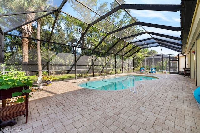 view of pool with a lanai and a patio