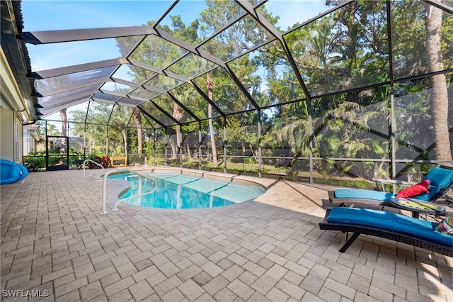 view of pool with a patio and a lanai