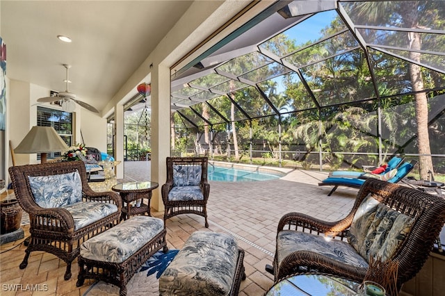 view of patio featuring a lanai, ceiling fan, and a fenced in pool