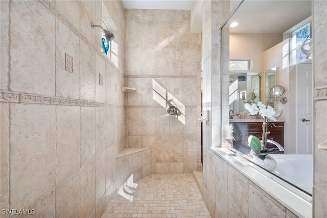 bathroom with tiled shower and tile walls