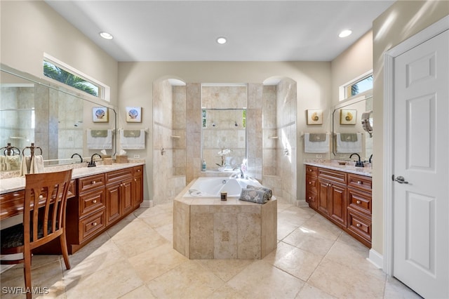 bathroom with tile patterned flooring, vanity, and separate shower and tub