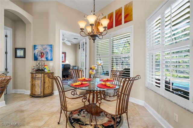 dining space featuring a notable chandelier and light tile patterned floors