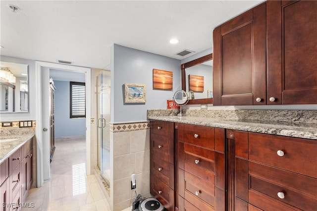 bathroom featuring walk in shower, tile walls, and vanity